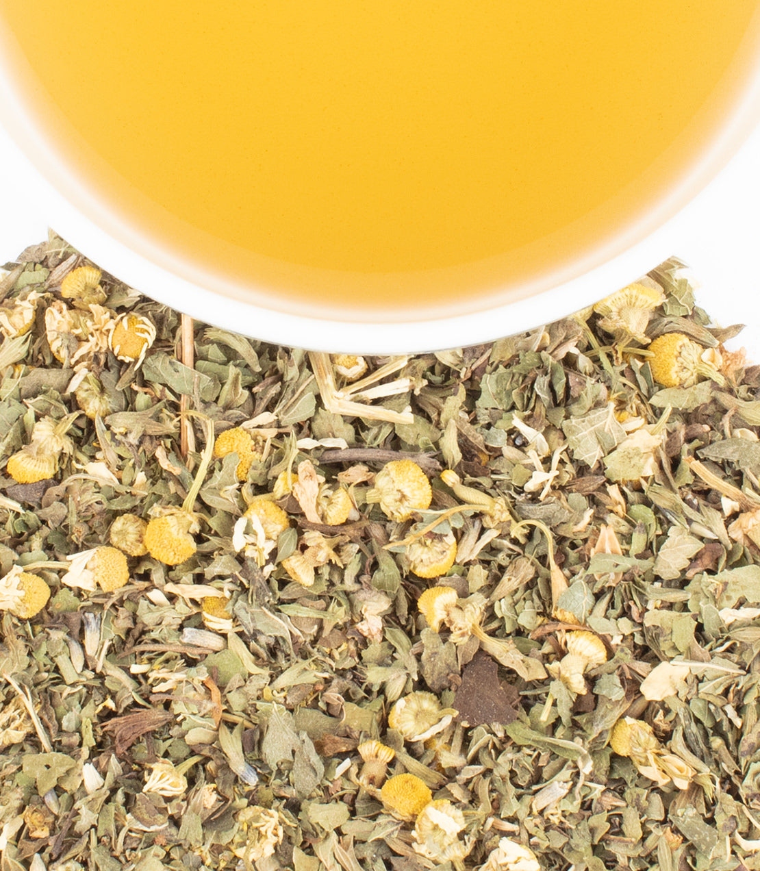 Organic Lemon Balm Chamomile tea sachets with dried herbs and a cup of brewed tea above. Perfect for relaxation.
