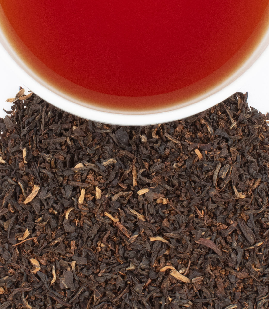 Safari Breakfast tea sachets, 50-pack, with loose black tea leaves and a cup of brewed tea.