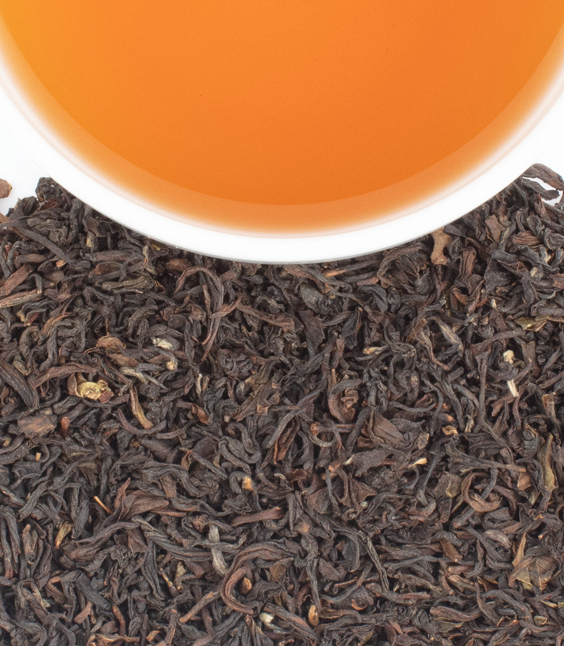 Teesta Valley 2nd Flush -   - Harneysd- Overhead shot of brewed tea over loose leaves