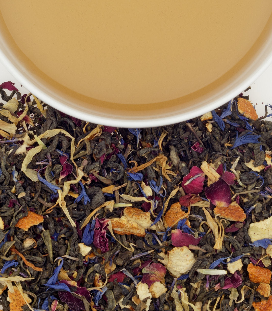 Bag of 50 Chinese flower tea sachets with dried flowers and herbs beside a cup of brewed tea.