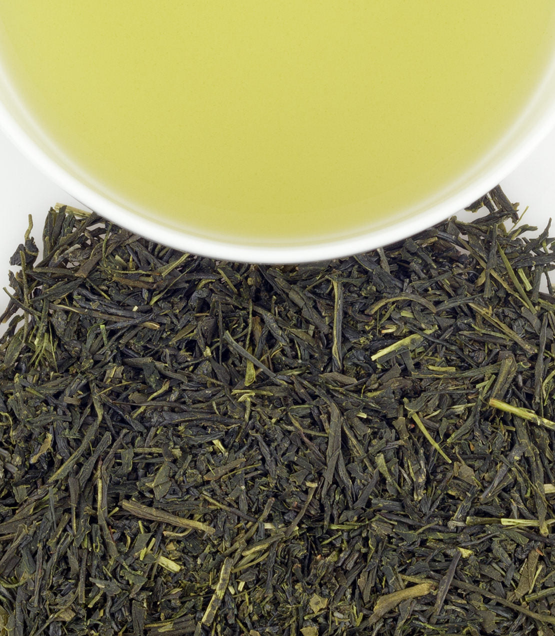 Classic tin of 20 sachets of Japanese Sencha tea, with brewed green tea and loose leaves displayed.