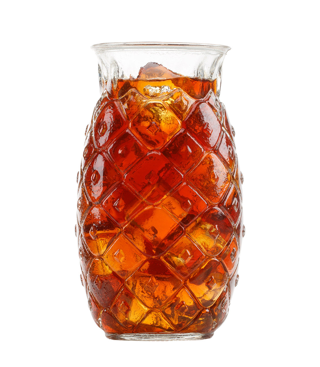Glass of Tropical Mango Fresh Brew Iced Tea with ice, served in a textured pineapple-shaped glass.