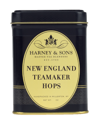 Black tin of New England Teamaker Hops by Harney & Sons, featuring gold accents and elegant branding.