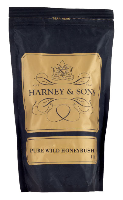 Black packaging of Harney & Sons Pure Wild Honeybush tea, featuring elegant gold accents and a tear-off top.