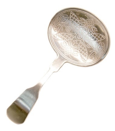 Stainless steel tea scoop with an oval shape and intricate punchwork design for elegant serving.